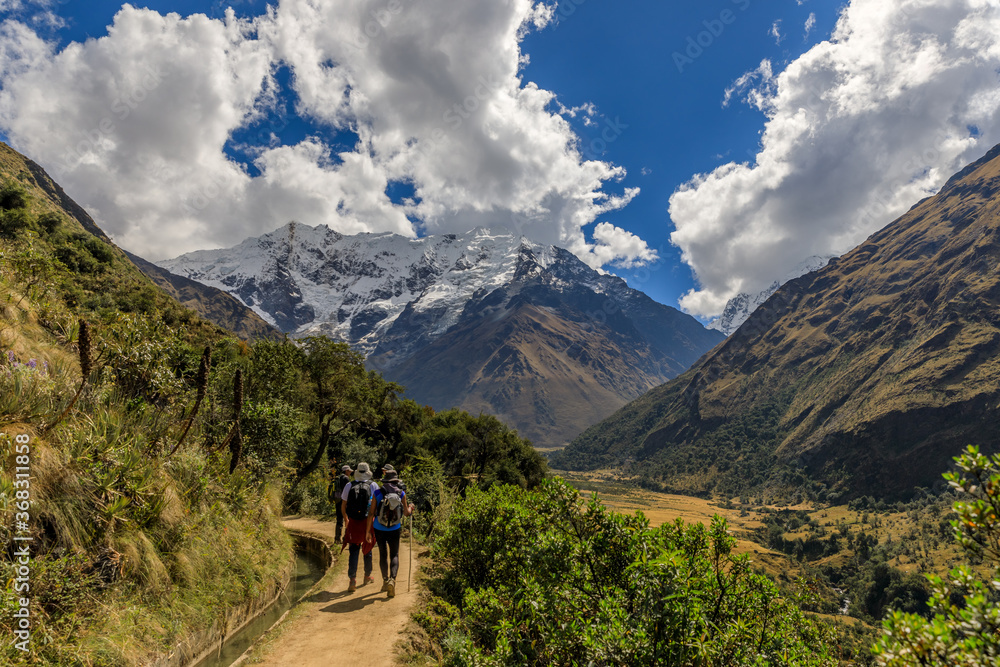 Four persons trekking towards Salkantay Mountain near Cusco, Peru.