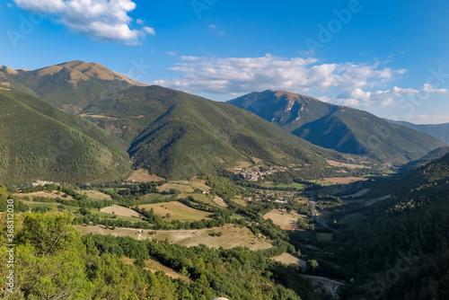 Large valley with farms  forests and mountains  with the Commune of Sant Anatolia of Narco in the center  Umbria region  province of Perugia  Italy