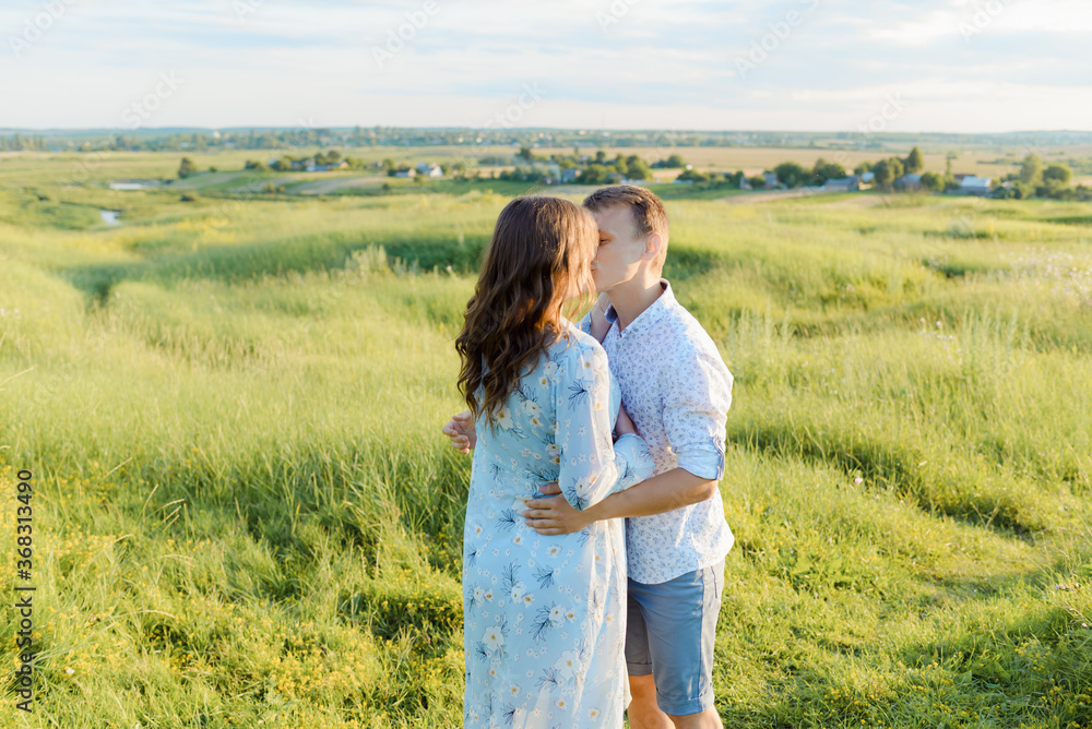 Portrait of a pregnant woman with her boyfriend. Happy couple expecting a baby, young family concept. High quality photo