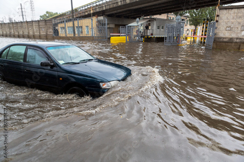 Odessa, Ukraine - September 20, 2016: Driving cars on a flooded road during flooding caused by torrential rains. Cars float on water flooded streets. The disaster in Odessa, September 20, 2016.