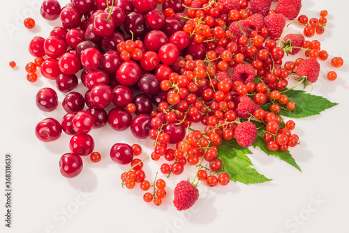 Assorted berry on a white background. Cherries, raspberries, red currants.