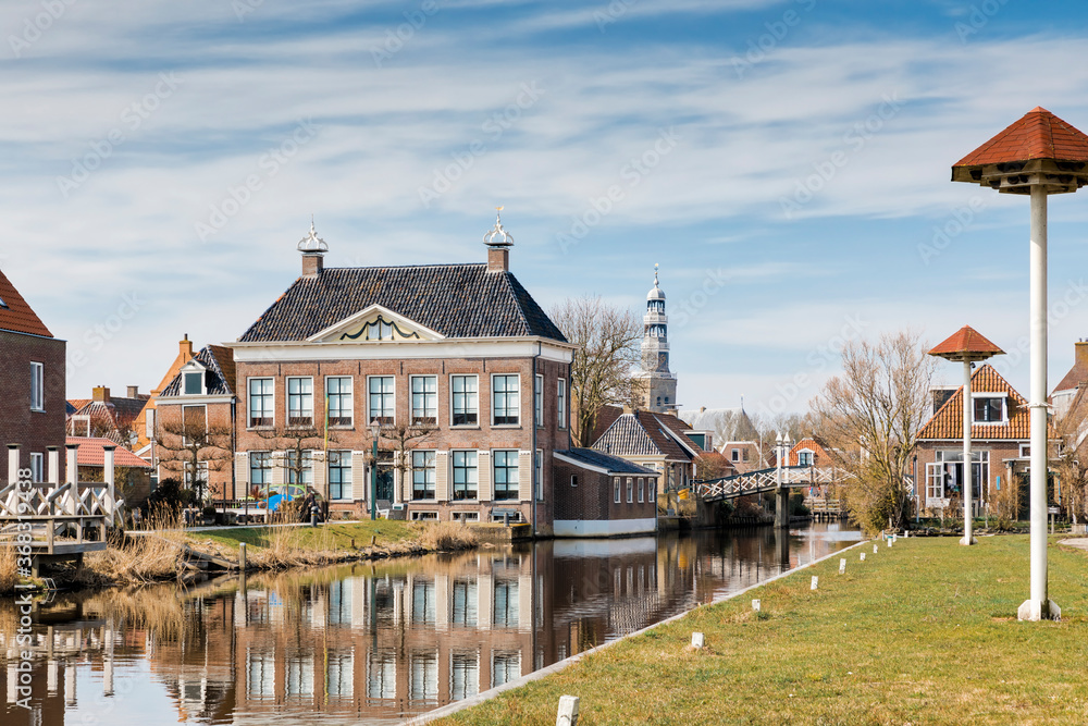 Residential buildings, canal and footbridge in Hindeloopen, Friesland, Netherlands, Europe