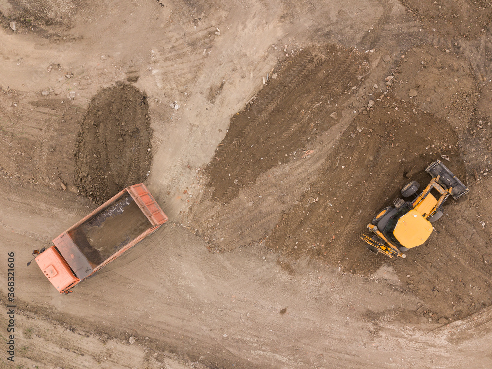 Road work. Large machine work on a new road construction site. Aerial view from drone shot. Road work. Large machine work on a new road construction site. Aerial view from drone shot.