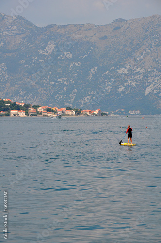 Kotor,Montenegro-08.01.2019 year. Close-up of a surfer with two ecotourists in the Bay of Kotor near the coast of the old city.