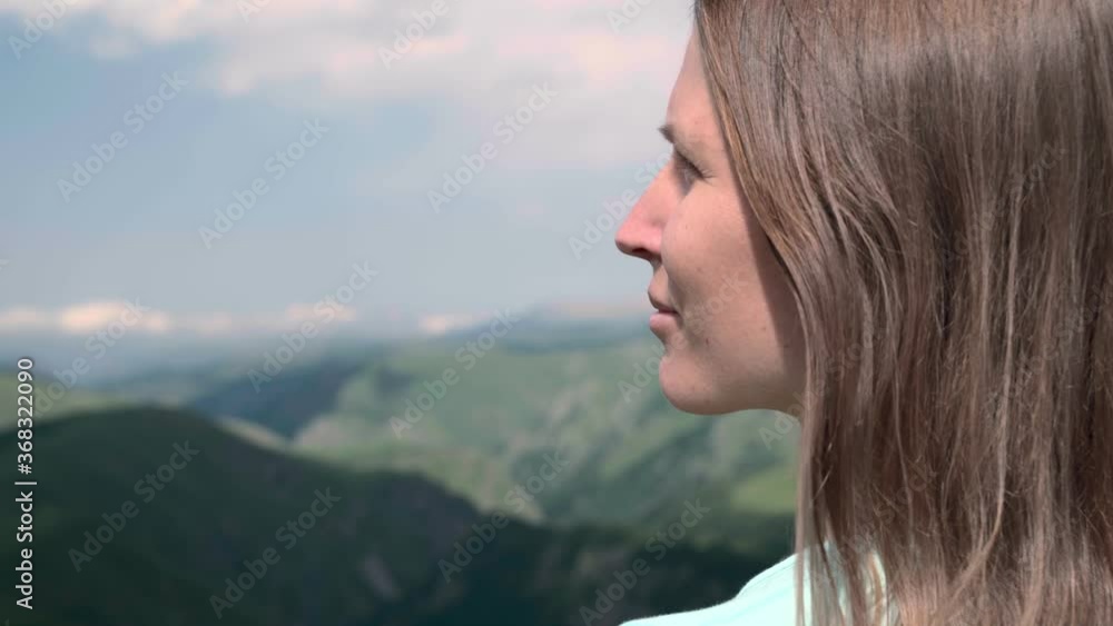 Young woman looking at mountain valley Young woman looking at mountain valley