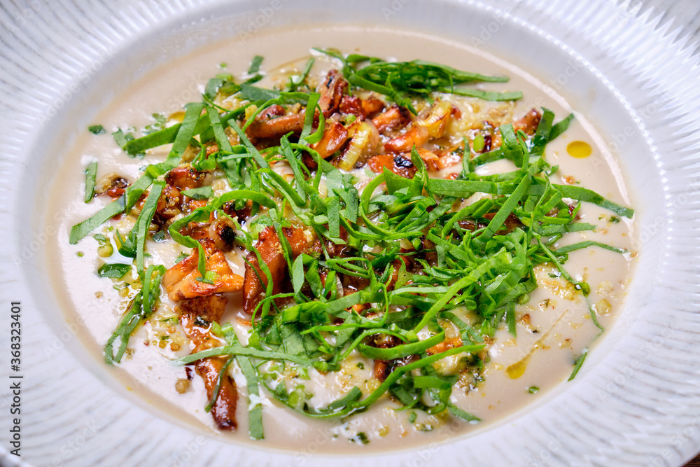 Mushroom cream soup in a white plate. Closeup. Mushroom cream soup in a white plate. Closeup.