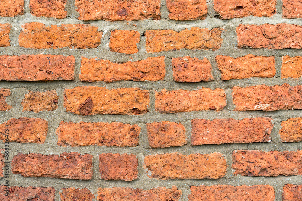 Fototapeta premium Full frame of rough brick wall close up as background