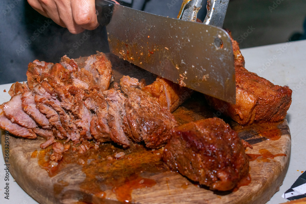 barbacoa de picaña en hoja de agave y a carbón. Stock Photo | Adobe Stock