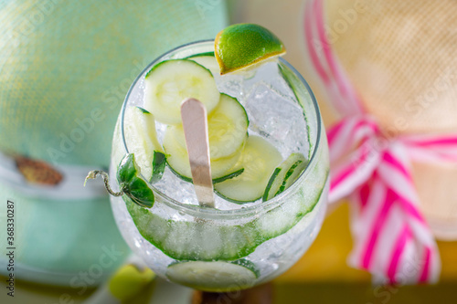 chopped gin and tonic on glass and hats surrounding it with love and passion