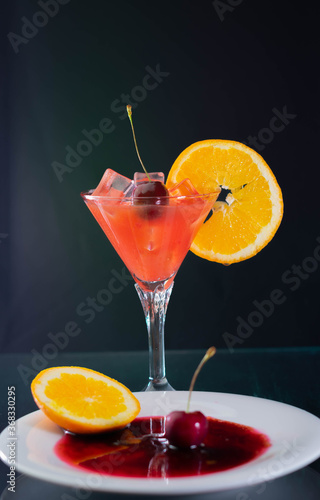 cold cocktail San Francisco on black background and shadow with cherry on red sugar