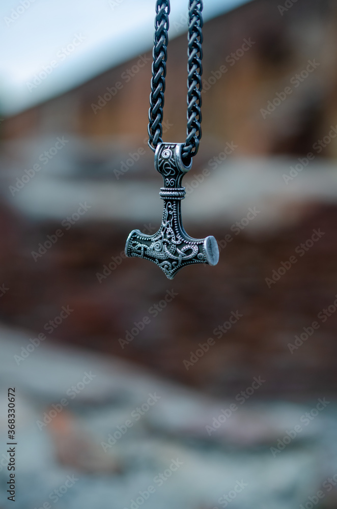 Thor's hammer as a symbol of war against the backdrop of destruction. Thor's hammer as a symbol of war against the backdrop of destruction.
