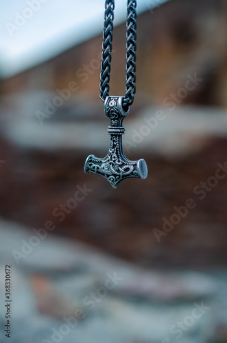 Thor's hammer as a symbol of war against the backdrop of destruction.