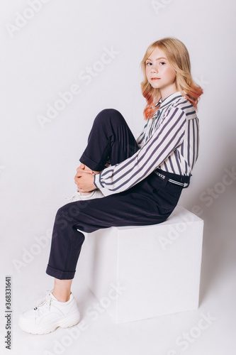 Back to school. Cute adorable caucasian blondie girl with glode in school uniform on white background photo