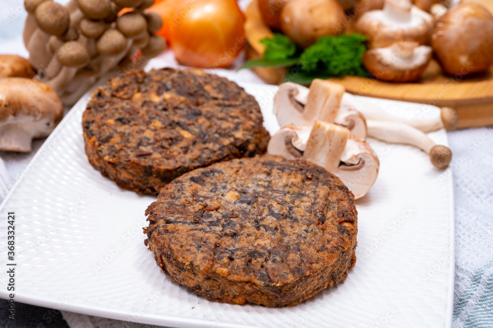 Tasty vegetarian food, burgers with champignons mushrooms, buna shimeji, carrot and onion Tasty vegetarian food, burgers with champignons mushrooms, buna shimeji, carrot and onion