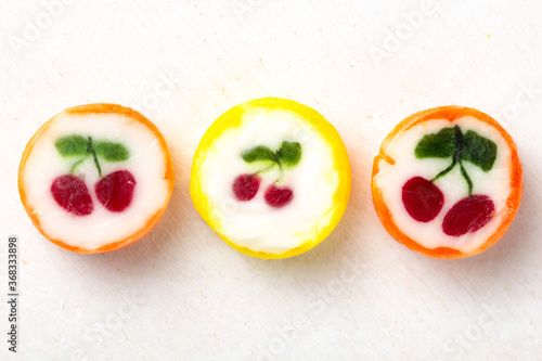 Three different colorful bright unwrapped round lollipops