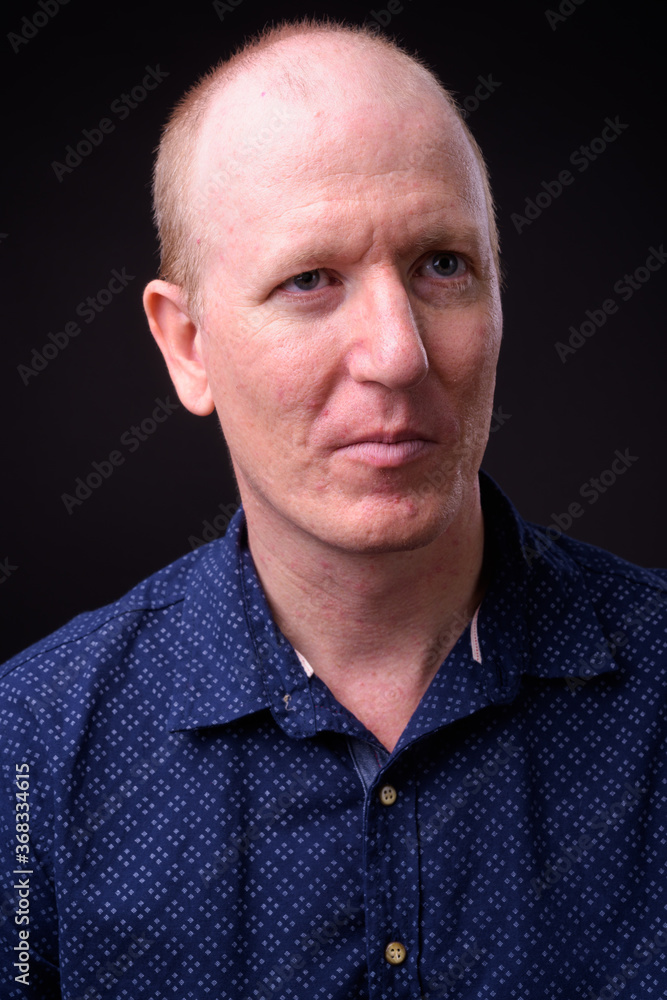 Face of bald businessman thinking and looking up Face of bald businessman thinking and looking up