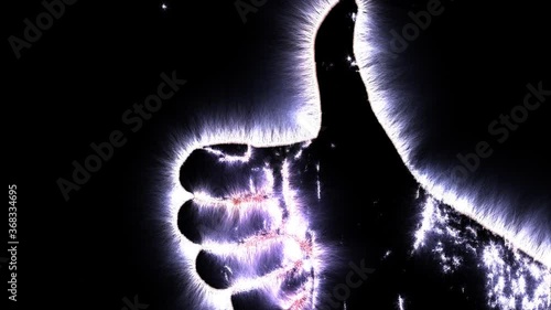 Kirlian aura videography of a male human hand showing different symbols and movement photo