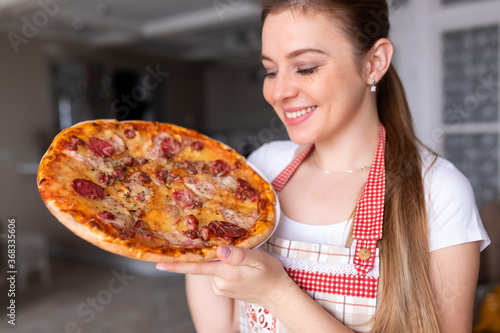 Happy Young Woman Cooking Pizza at Home.