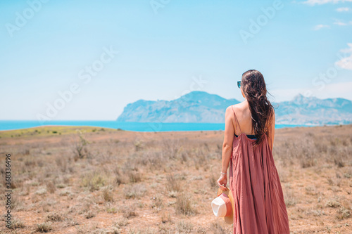 Tourist woman outdoor on edge of cliff seashore