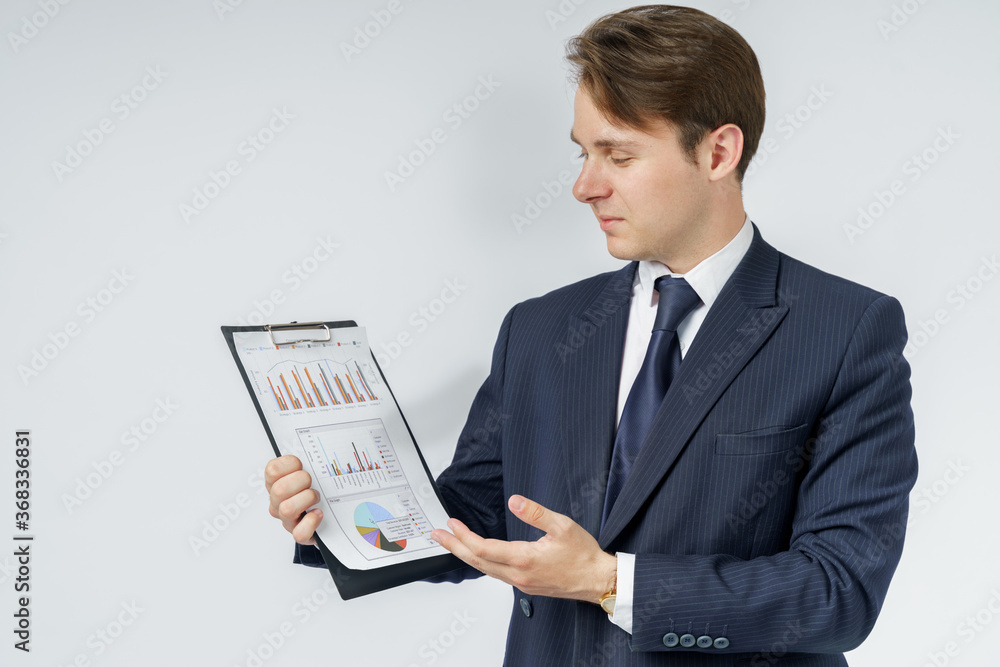 Businessman holds in his hands a tablet with reports. White background. Businessman holds in his hands a tablet with reports. White background.