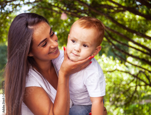 young pretty brunette mother with little cute boy walking in park happy smiling, lifestyle people concept © iordani