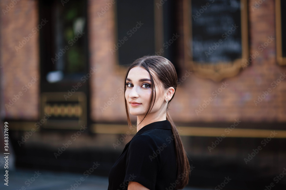 Portrait of a girl in the city. Girl in a black dress. Young beautiful woman. Makeup. Pretty Girl. Portrait of a girl in the city. Girl in a black dress. Young beautiful woman. Makeup. Pretty Girl.