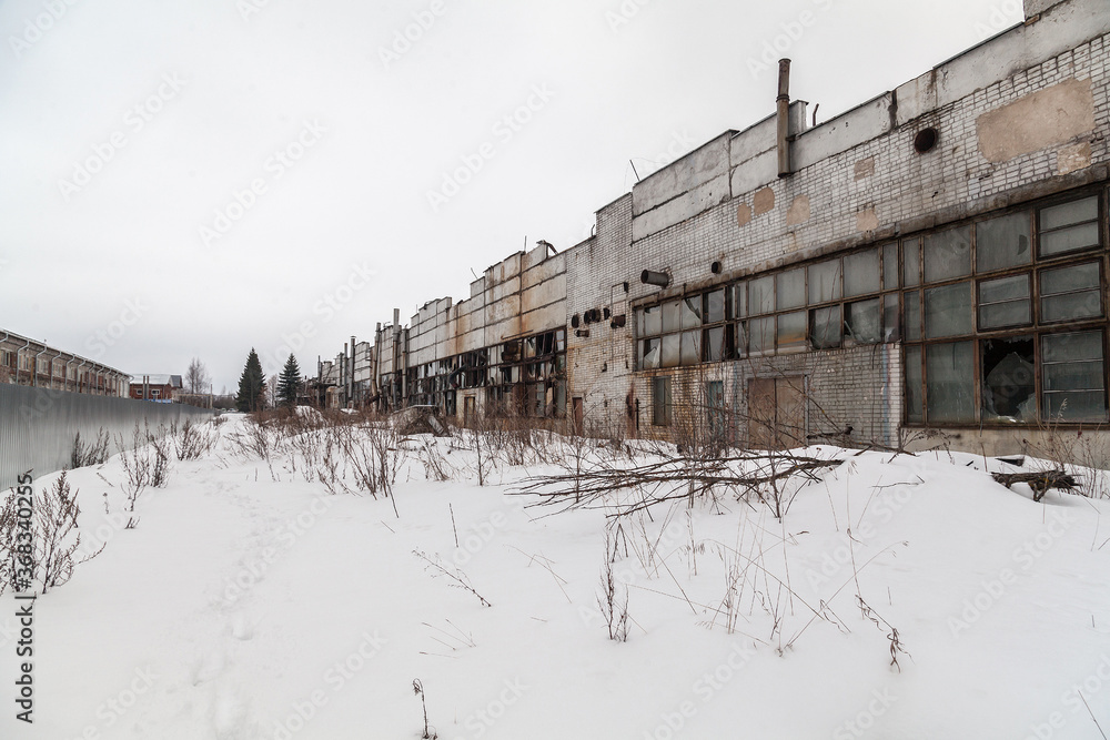 Abandoned soviet factory facade in winter time