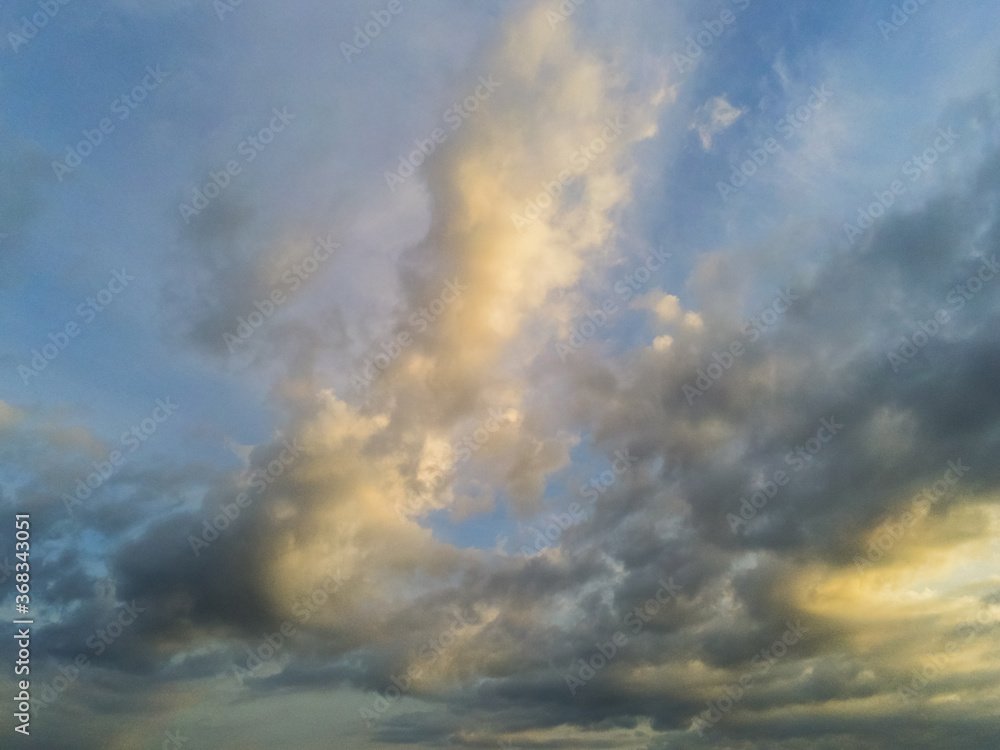 Beautiful cloudy sunset sky with blue and yellow tones. Beautiful cloudy sunset sky with blue and yellow tones.