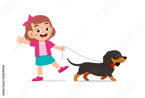 happy cute little kid boy girl play with pet dog