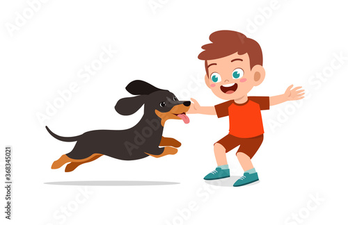 happy cute little kid boy girl play with pet dog