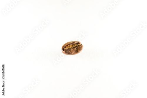 Closeup of a single roasted coffee bean, isolated on a white background