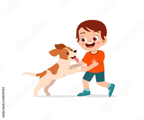 happy cute little kid boy girl play with pet dog