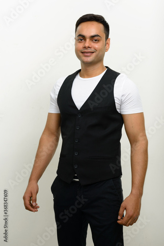 Portrait of happy young handsome Indian businessman