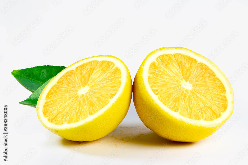 Fresh sliced lemon with leaves, isolated on white background