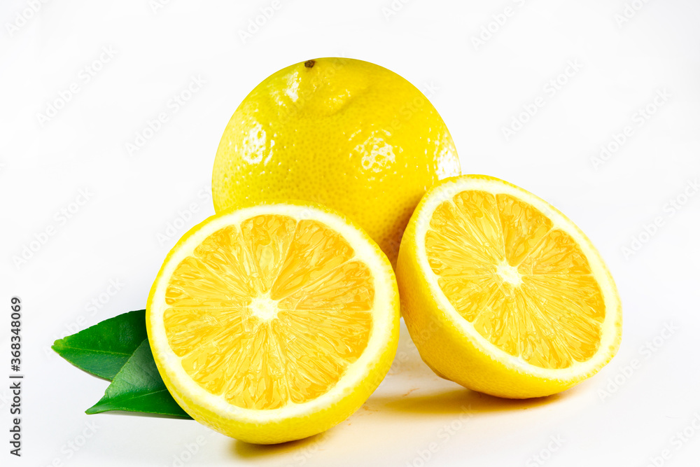 Fresh juicy lemon with leaves, isolated on white background