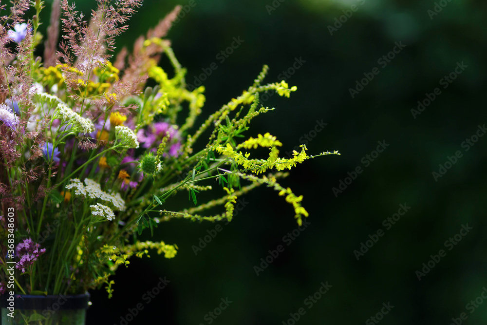 Bouquet of wild flowers in vase in a garden Bouquet of wild flowers in vase in a garden