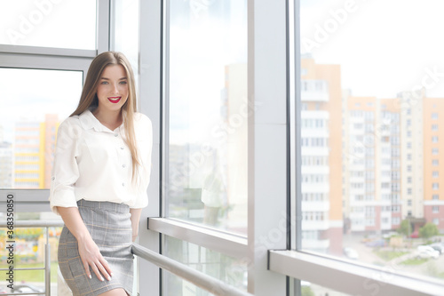 young female student sitting in the office solving problems