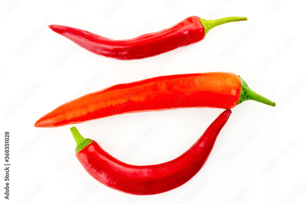red pepper bright spicy tasty three vegetable pods white isolated background
