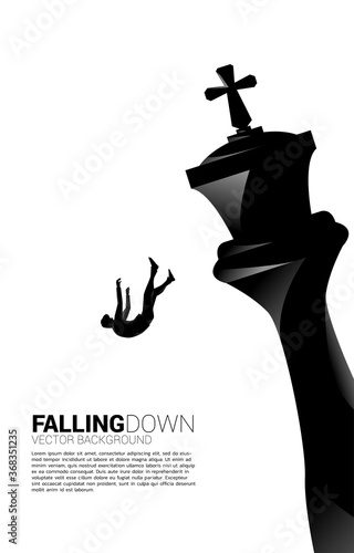 Silhouette of businessman falling down from the king chess. concept of business strategy and fail situation.