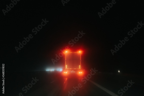 tail light of truck at night during rain