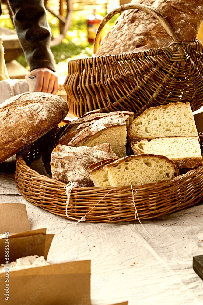 slices of sliced rustic bread stacked in a wicker basket vertical photos warm colors