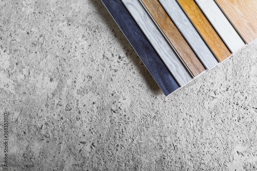 laminate flooring planks variations on concrete floor © nikkytok