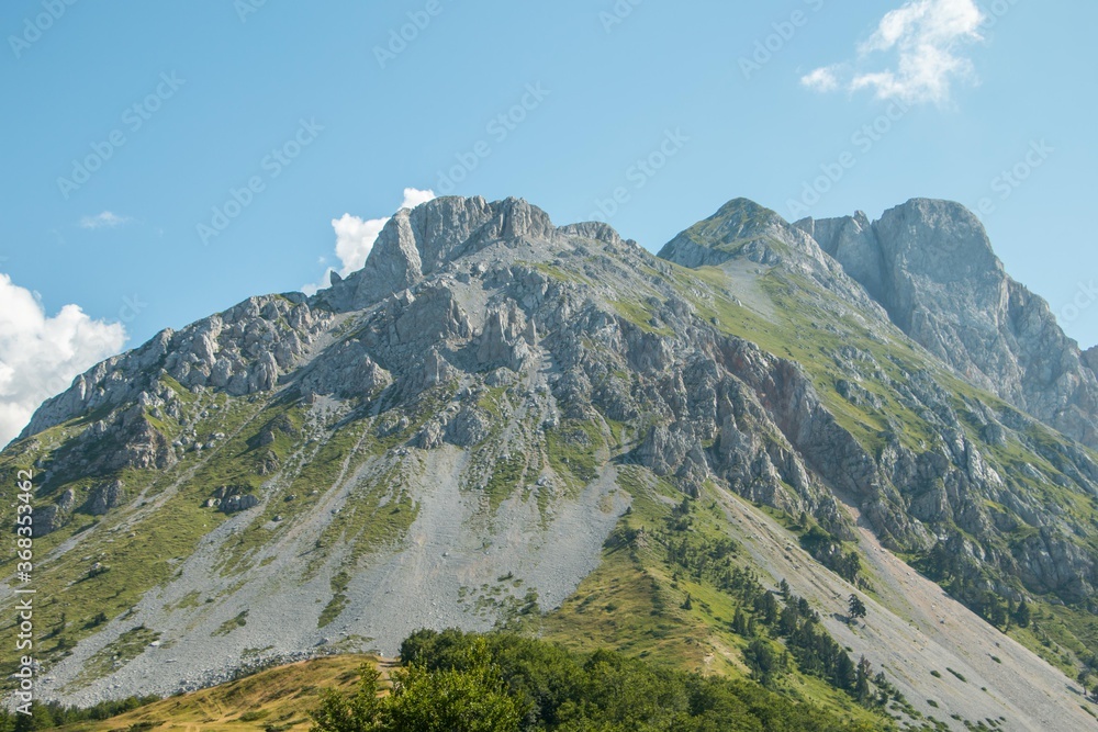 Mountain areas in summer. Beautiful views of the mountain peaks. Mountain Kom, Montenegro Mountain areas in summer. Beautiful views of the mountain peaks. Mountain Kom, Montenegro