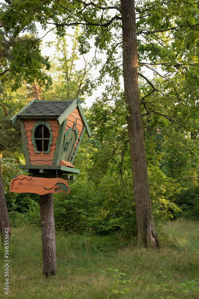 Small bright wooden decorative treehouse in an amusement park