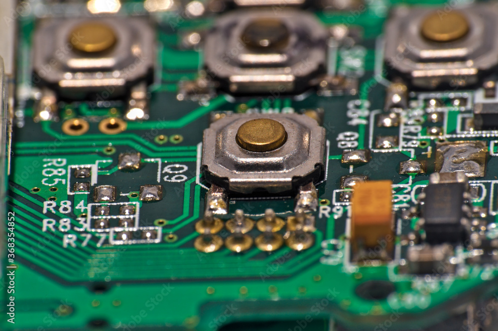 Green Circuit board, components and wires, macro photograph. Science and technology themes Green Circuit board, components and wires, macro photograph. Science and technology themes