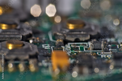 Green Circuit board, components and wires, macro photograph. Science and technology themes