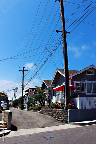 Electric poles on a small street. A street with private homes and electric poles in a residential area of California.