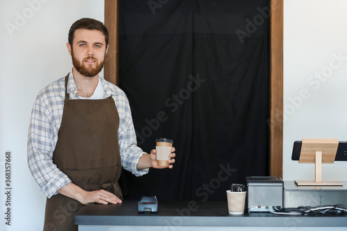 Male barista in modern cafe
