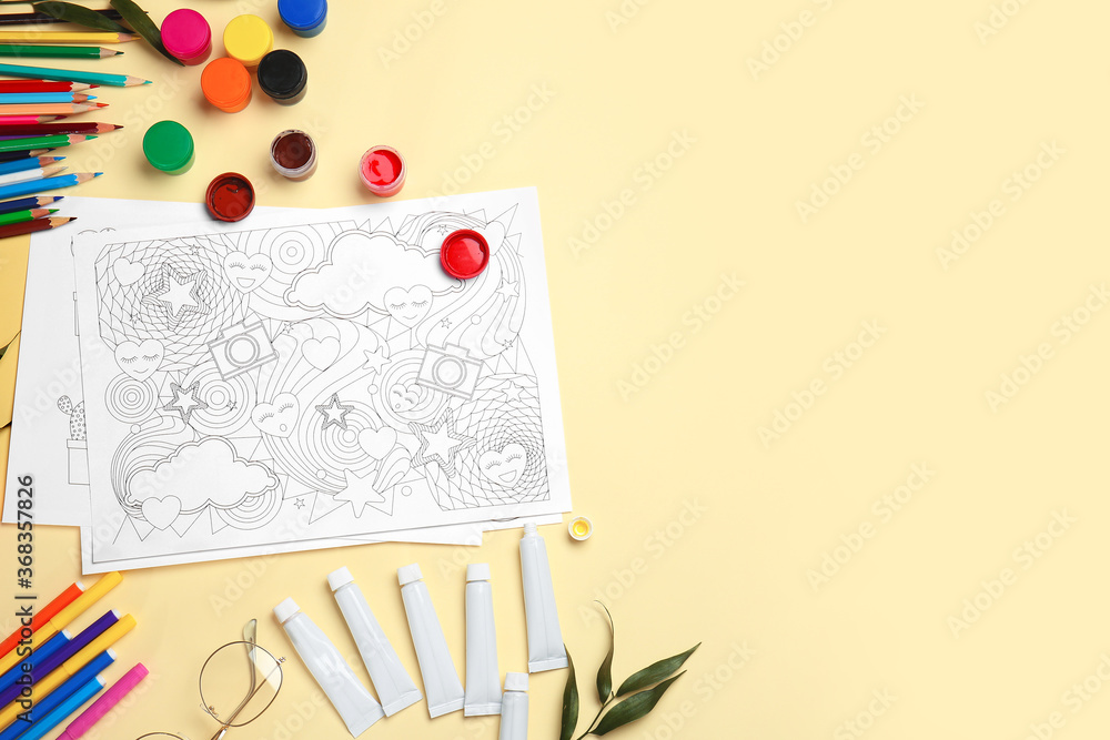 Composition with coloring pictures on table Composition with coloring pictures on table