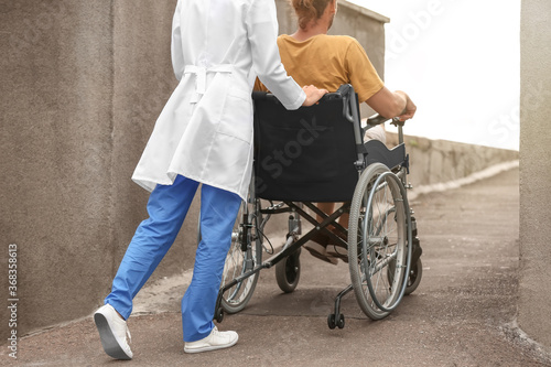 Doctor and young man in whe...